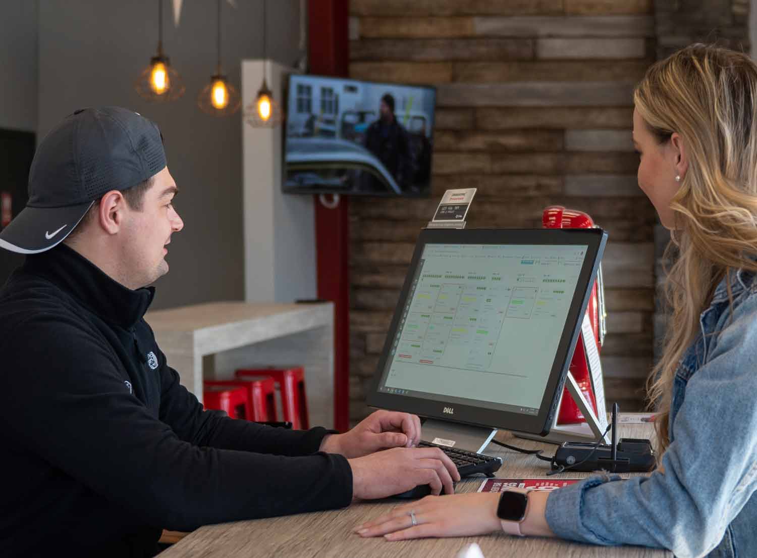two people looking at a computer screen showing a purchase