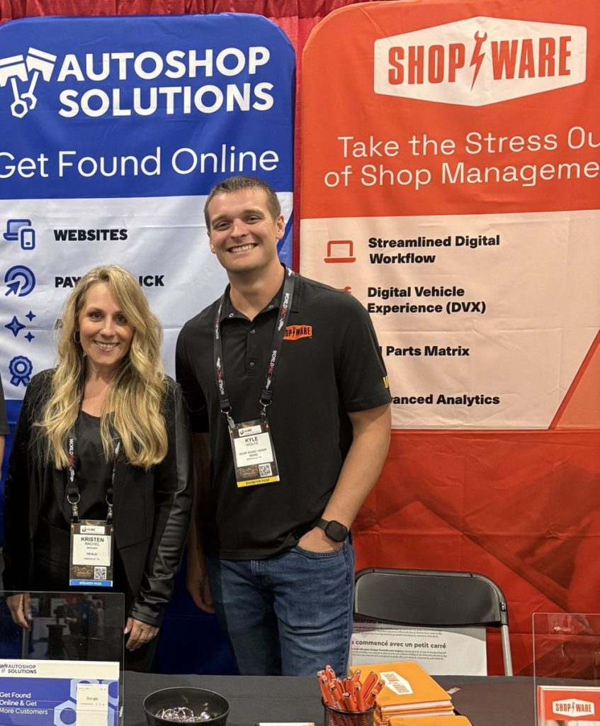 Three team members at the shared Shop-Ware booth at ASTA Expo 2026, in front of Shop Boss, Autoshop Solutions, and Shop-Ware banners